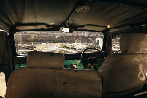 The cabin of an old car in rocky mountains