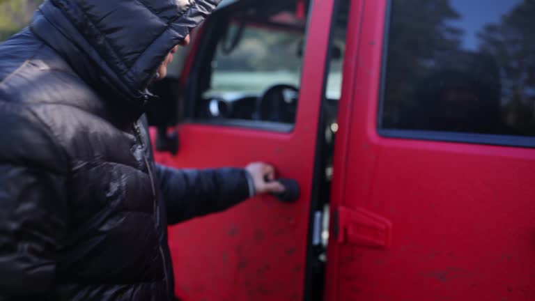 Man runs opens door of red SUV jeep