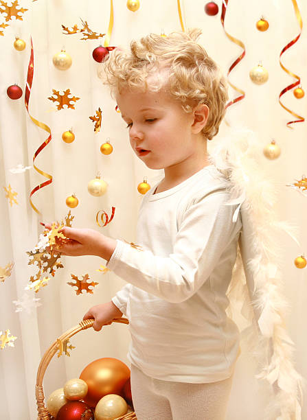 sweet angel boy with gold stars confetti stock photo