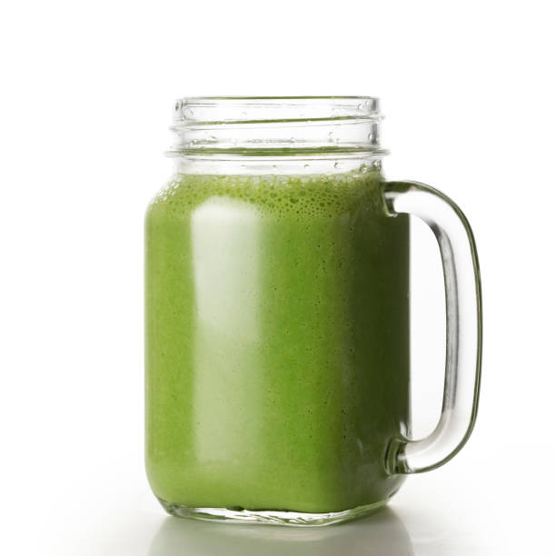 istock Green juice in mason jar on white background. 1447208568