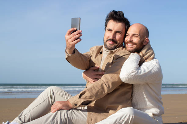 istock Gay couple posing for selfie on beach 1447209578