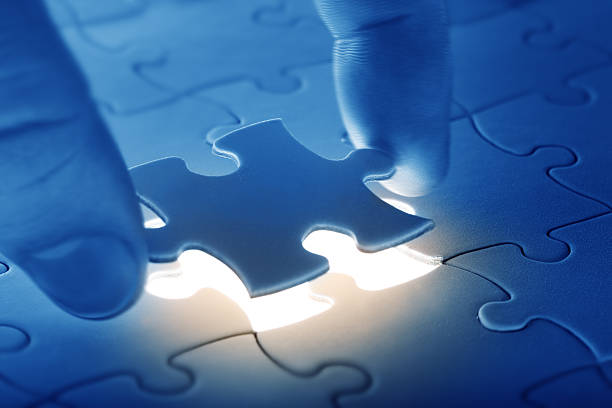 istock Somebody placing the  last piece of a puzzle 144721079