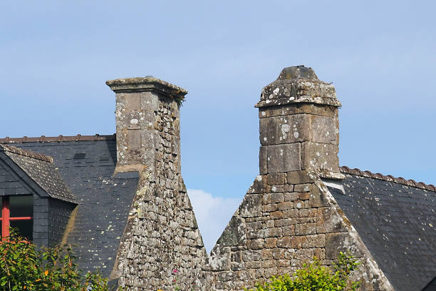 Throughout Brittany, the large granite houses are surmounted by solid chimneys
