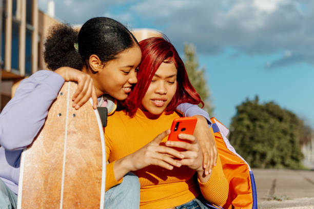 istock young girls using phone 1447211359