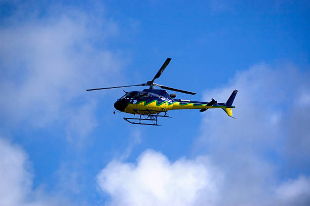 Yellow-blue Helicoper in the sky Yellow-blue Helicopter in the sky flying high. Side view. airfoil photos stock pictures, royalty-free photos & images