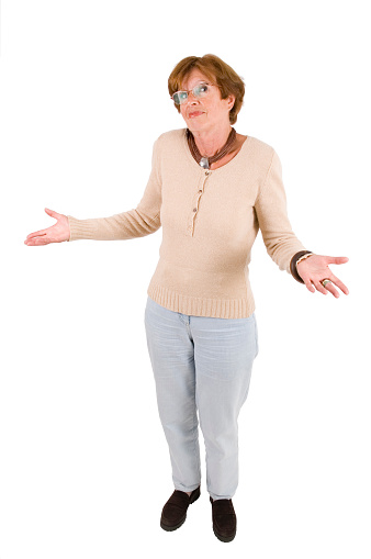 Mature woman with shrug of shoulders in full shot; isolated on white background.