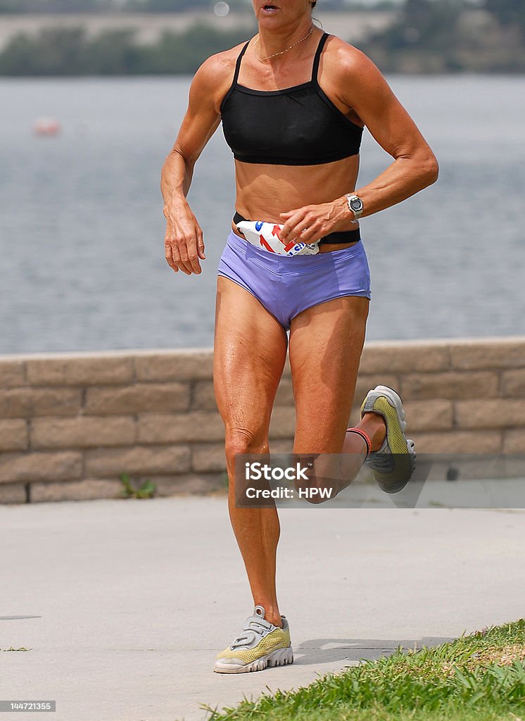 Female Runner female runner in 10K run segment of triathlon  Active Lifestyle Stock Photo