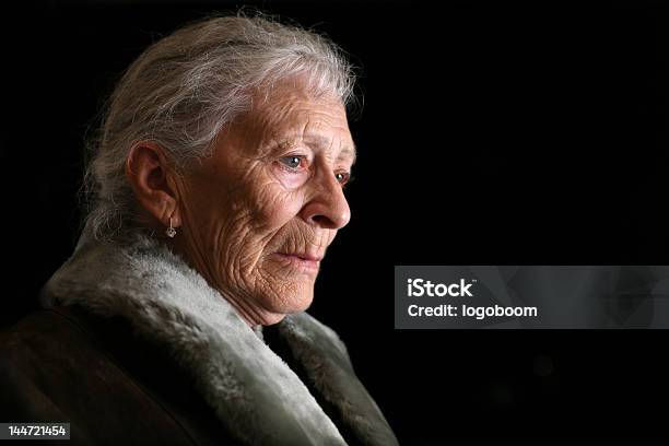 Senior Woman Contemplating Stock Photo - Download Image Now - Sadness, Black Background, Black Color