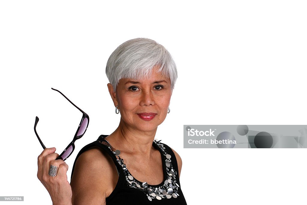 woman with sunglasses Attractive mature woman holding a pair of sunglasses Adult Stock Photo