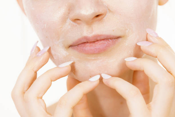 istock Girl with cream moisture cosmetic on face 1447218686