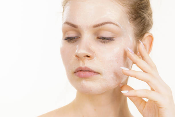 istock Girl with cream moisture cosmetic on face 1447219232