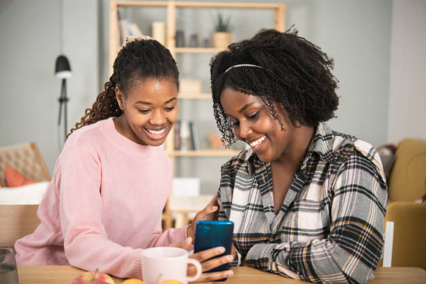 istock Two female friends using a smartphone together 1447220230