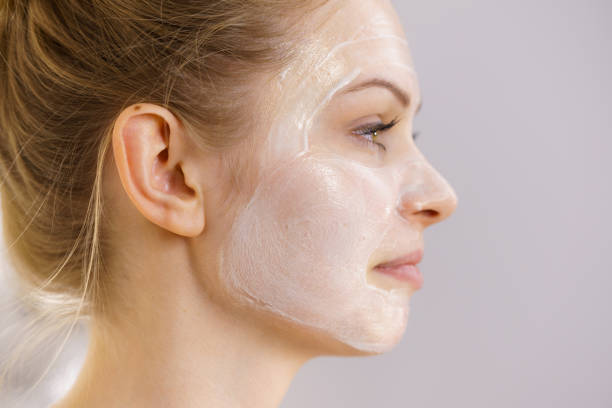 istock Girl with cream moisture cosmetic on face 1447220968