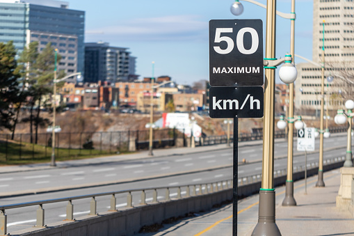 Speed limit road sign in the street, 50 km per hour maximum in Ottawa city, Canada. Driving rules