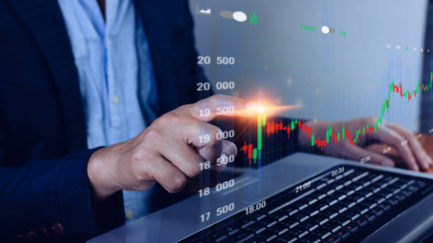 istock Businessman finger touch symbol stock graph and chart background, concept growth and development business investment, Stock market and strategy making market plan and stock market fluctuations 1447221241