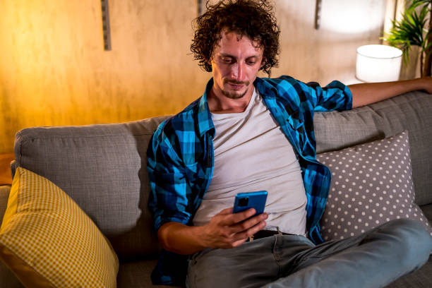 istock Young man relaxing at home 1447228011