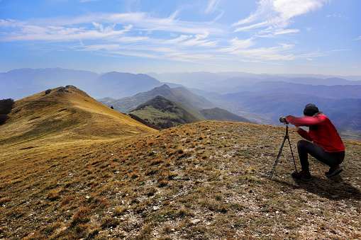 A photographer shooting the view from Monte Cappucciata, in Abruzzo