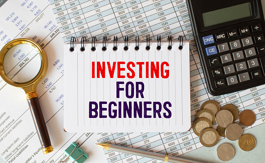 INVESTING FOR BEGINNERS . text on white paper on gray background.