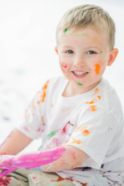 istock Little Boy Finger Painting Mess 1447234475