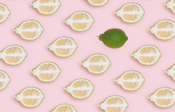 istock Pattern made with green lemon, lime slice on patel blue background. Minimal citrus concept. 1447234967