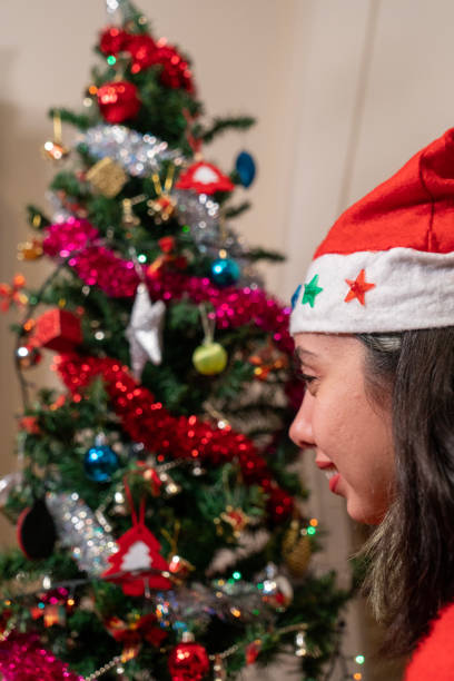 istock young woman decorates the new year tree 1447236247