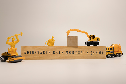 Adjustable rate mortgage ARM written on wooden surface. Mortgage and finance