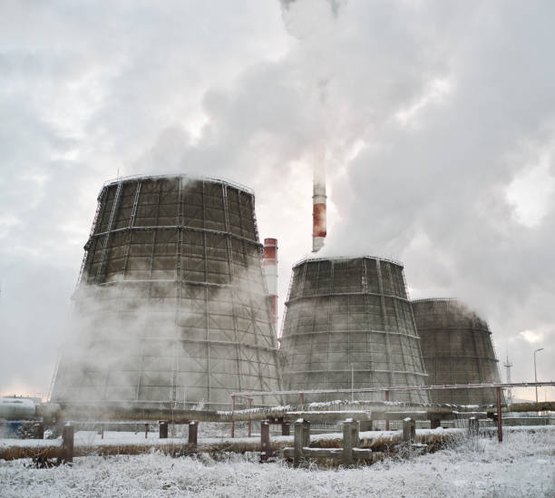 istock Pipes with smoke in winter, snow-covered ground 1447241437