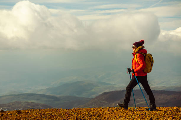 istock Young female hiker walks on a mountain cliff 1447242689