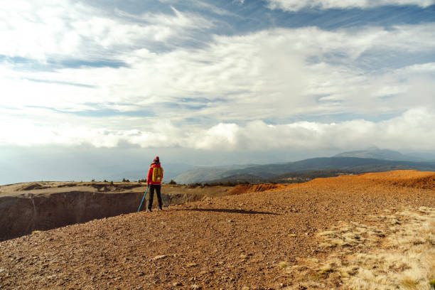 istock Female hiker resting and enjoying the view from a mountain peak 1447242918