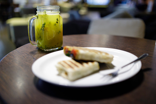 vegan breakfast: wrap with grilled vegetables and hot orange infusion with rosemary