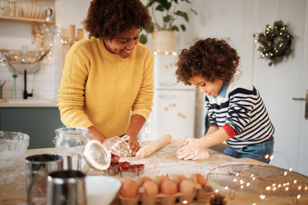 istock Mother making cookies in the kitchen with her cute toddler son 1447243749