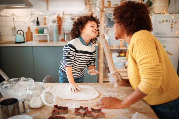 istock Mother and son making cookies together 1447243766