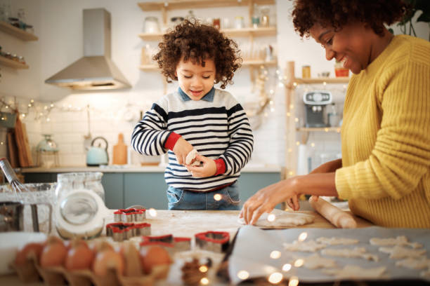 istock Mother and son having fun baking cookies together 1447243780