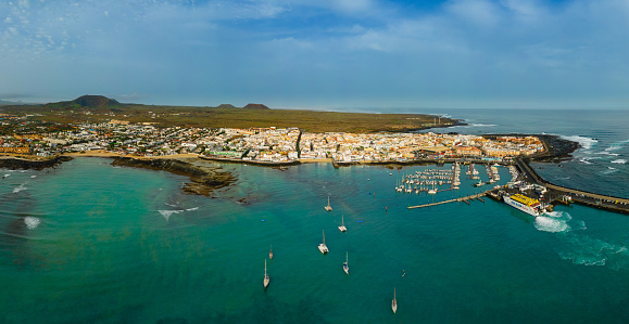 Mid level aerial panoramic view of Corralejo harbour, town and beaches, Fuerteventura