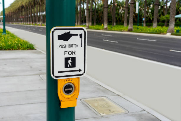 Push Button For Crossing sign on a green post stock photo
