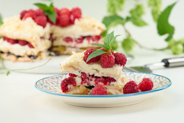 istock Round meringue pie with fresh raspberries on a white background, Pavlova dessert 1447246670