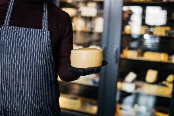istock A man holds in hands cheese at the cheese factory. 1447247500
