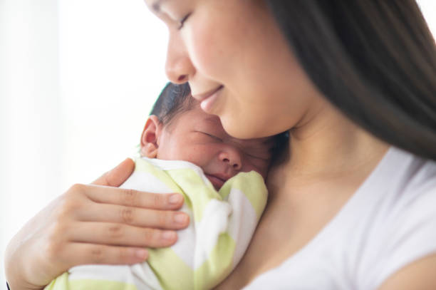 istock Mother Holding Her Newborn 1447247961