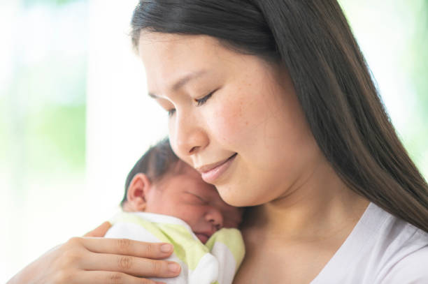 istock Mother Holding Her Newborn 1447247966