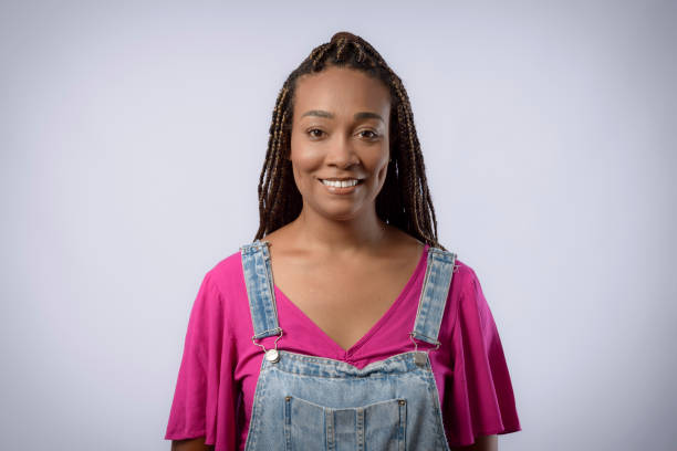 istock Young woman with afro hair with braid in studio on gray background 1447248009