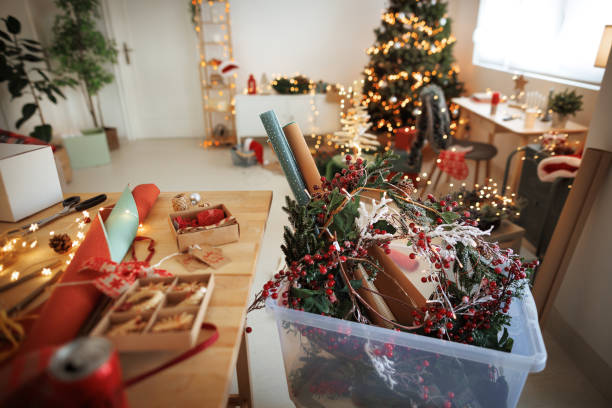 Creative mess Christmas decoration on a wooden table in a cozy modern apartment with no people christmas chaos stock pictures, royalty-free photos & images