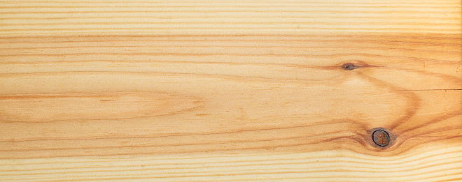 Bright pine board texture with knots and crack.