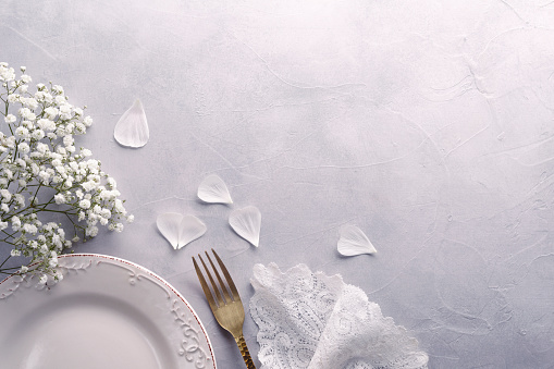 Wedding table with white flower,gold fork and napkin