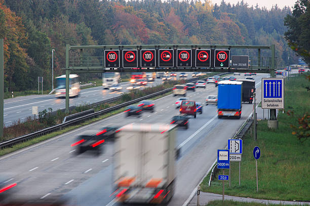 traffic on german autobahn with speed limit signs traffic on german autobahn with speed limit signs, shot at twilight, slight motion blur autobahn stock pictures, royalty-free photos & images