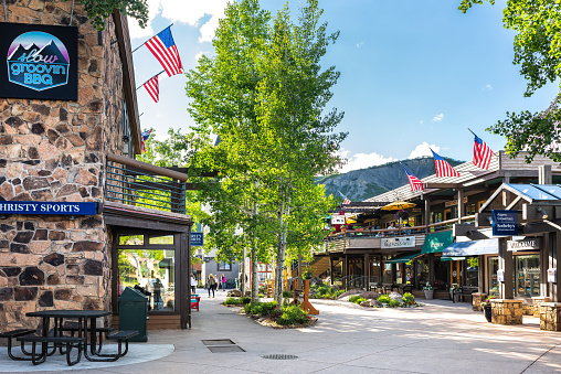 Aspen, USA - June 24, 2019: Snowmass village town city with strip shopping mall in Colorado downtown with sports store and Sotheby's real estate