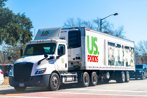 Jamestown, USA - February 3, 2021: US Foods food delivery distribution truck car vehicle with trailer transporting products in South Carolina