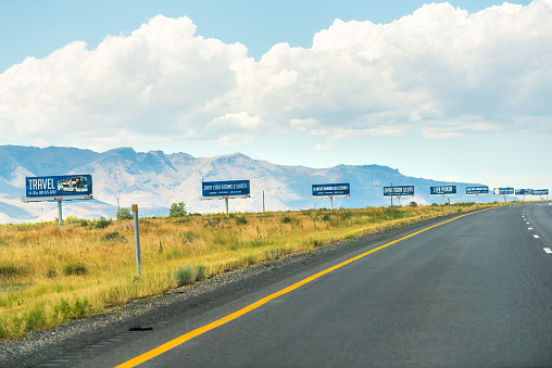 Bonneville Salt Flats, USA - July 27, 2019: Row of roadside advertisement billboards at Utah Lincoln interstate highway 80 road near Wendover, Nevada