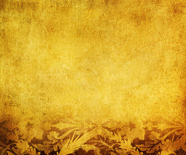 istock A grungy yellow background with autumn leaves on the bottom  144725710