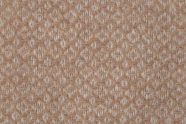 istock Brown and white geometric woolen fabric throw background 1447259355