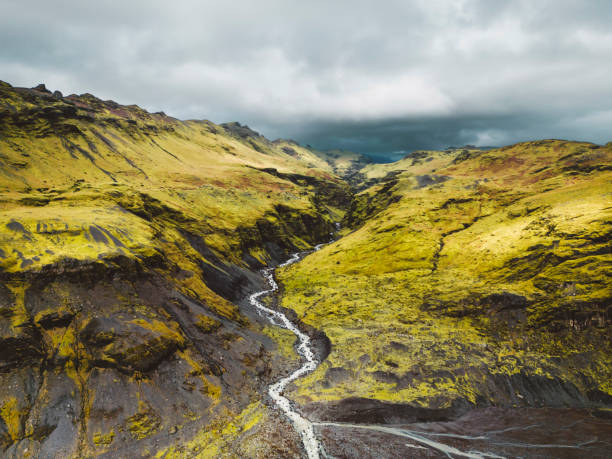 istock Glacier River flowing trough volcanic Icelandic landscape - cliffs and hills 1447260593